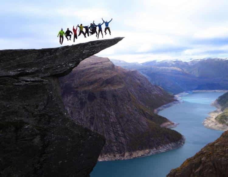 Jumping on the Trolltunga rock in Norway High Place