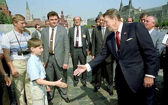 Vladimir Putin (far left) as a young KGB spy, meeting Ronald Reagan. Young Celebrity