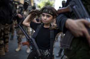 A Palestinian girl with a Kalashnikov rifle, amid Islamic Jihad militants in Gaza City Human Diversity